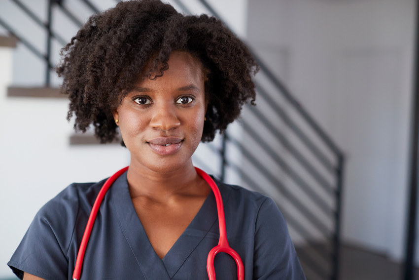 Portrait Of Female Nurse Wearing Scrubs In Hospital