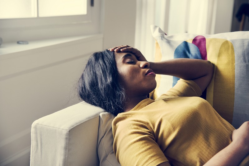 Black woman headache and sleeping