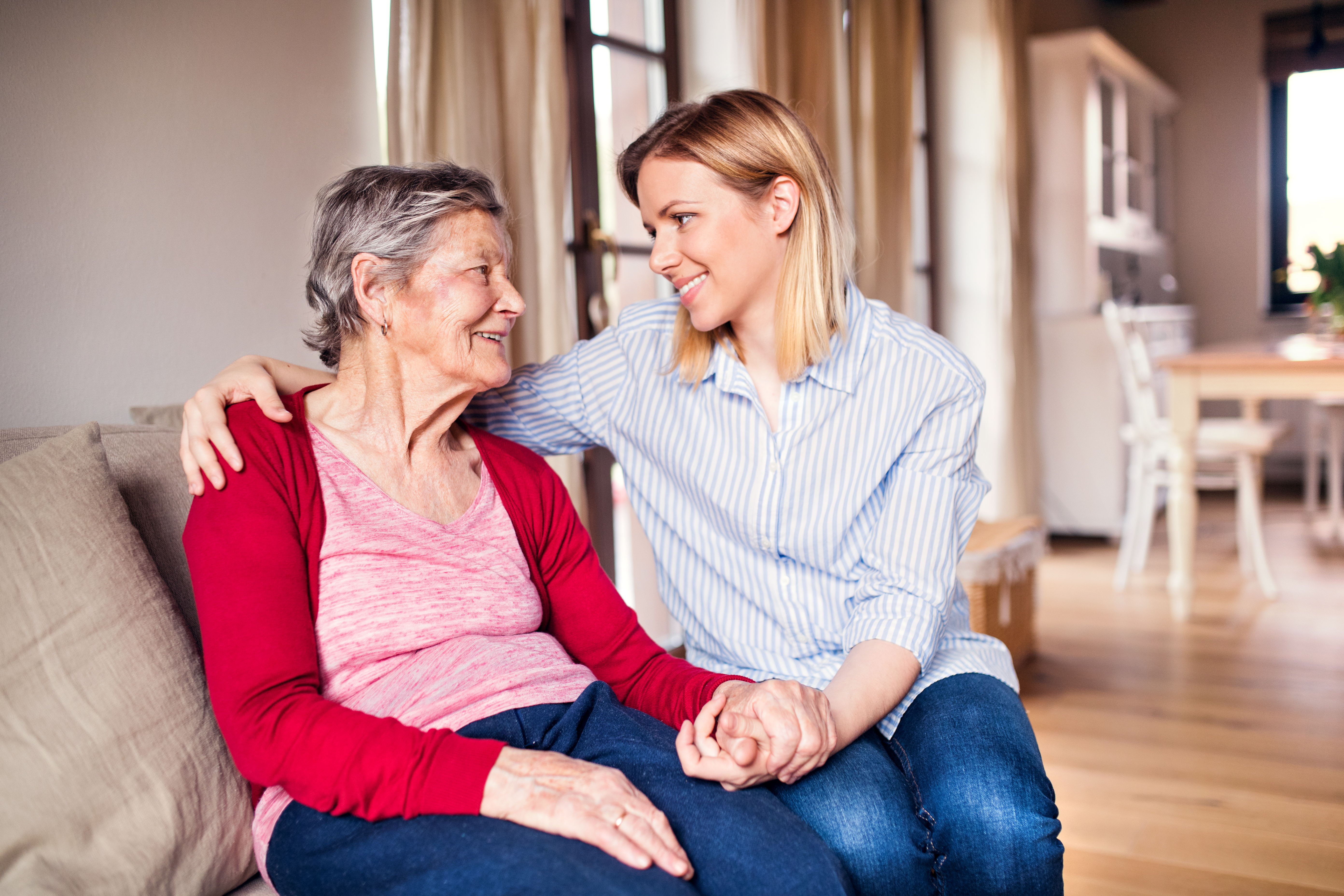 An elderly grandmother with an adult granddaughter at home.