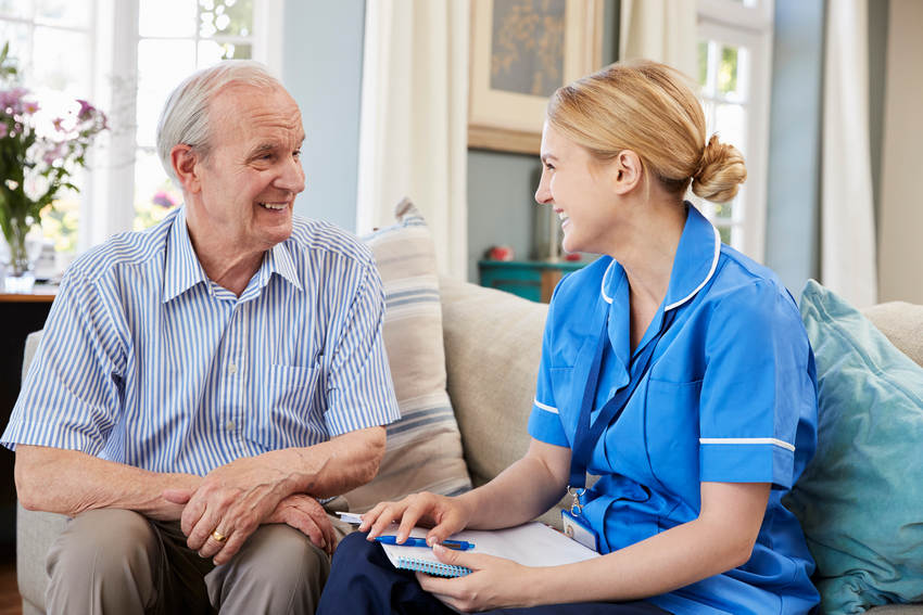 Female Community Nurse Visits Senior Man At Home