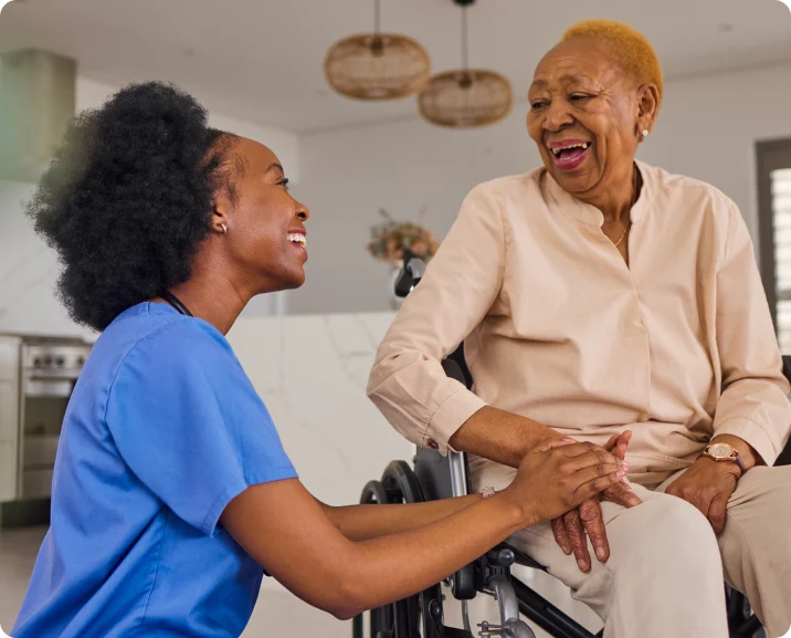 A woman in a wheelchair speaks with an older woman, showcasing the significance of elderly care services in community support.