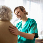 Friendly home caregiver supporting an elderly lady How to Become a Personal Care Assistant