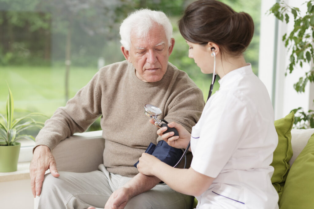 Young medic taking blood pressure Best elderly homes in Harrisburg