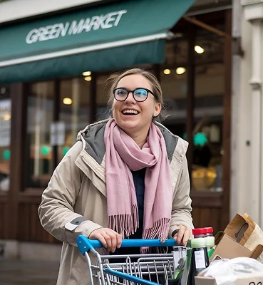 Senior woman grocery shopping with assistance and independent living support