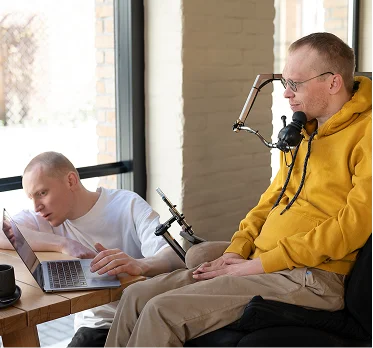 Man using assistive communication device while receiving disability support at home