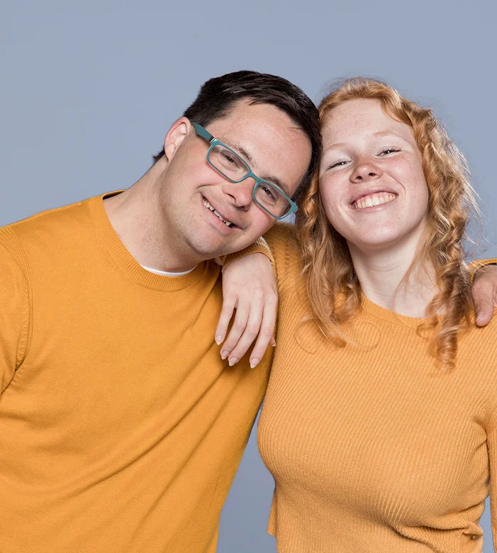 Young adults with Down syndrome smiling together in inclusive lifestyle portrait