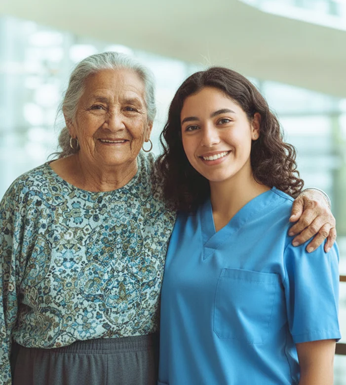 Friendly caregiver standing beside smiling senior woman during personalized home care support