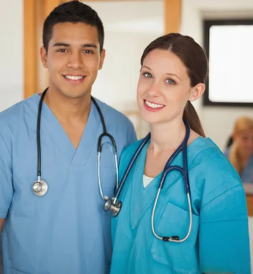 Friendly healthcare professionals posing together in medical uniforms