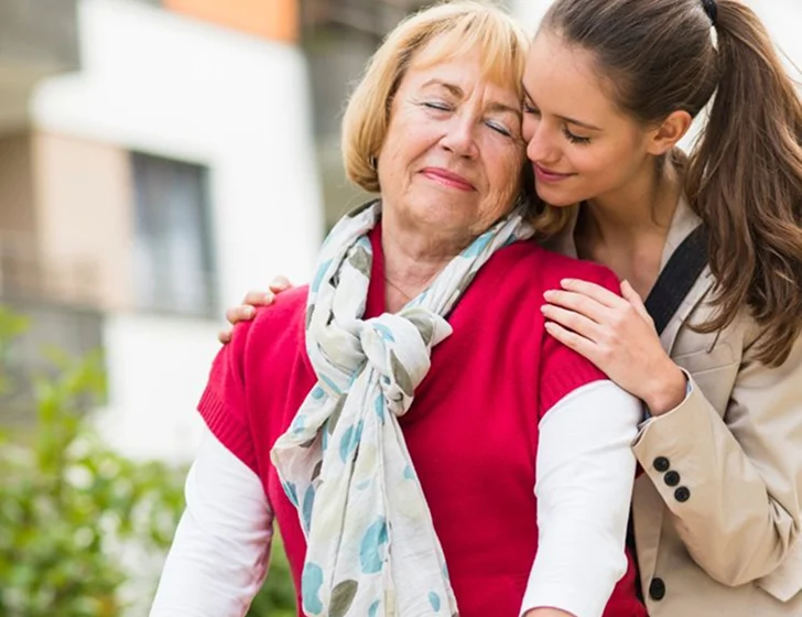 Young woman comforting senior woman with supportive outdoor companionship
